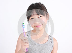 Cute girl brushing her teeth