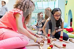 Cute girl building a structure in balance during playtime at the