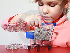 Cute girl care play with toy shopping trolley