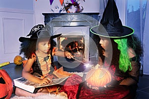 Cute girl cast magic spell on Halloween pumpkin