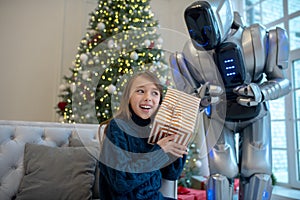 Cute girl with christmas gift looking excited