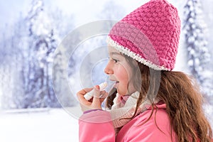 Cute girl clothes applying lip balm