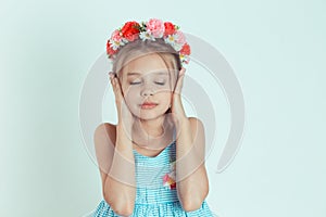 Cute girl covering ears with her hands eyes closed