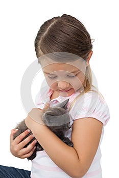 Cute girl cuddling grey kitten