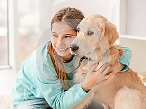 Cute girl cuddling lovely dog