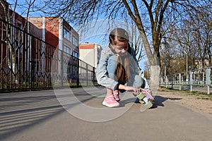 cute girl in denim and pink sneakers and penny board, longboard . International Skateboarding Day.