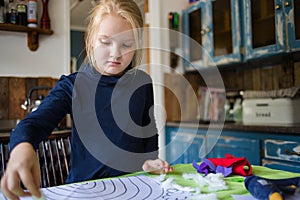 Cute girl doing creative activities at home while in lockdown due to the covid-19 outbreak of 2020