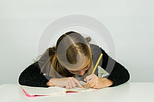 Cute girl is doing her homework