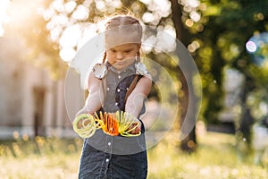 Cute girl with Down& x27;s syndrome playing outside, intellectual disability problem