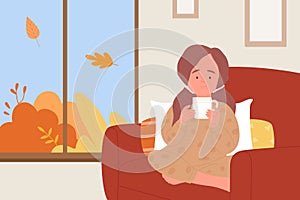 Cute girl drinking hot drink at home, kid holding tea cup to keep warm in autumn weather