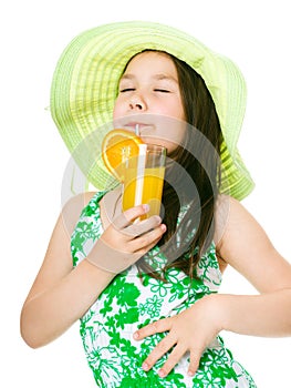 Cute girl is drinking orange juice