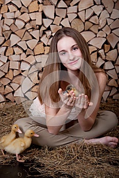 Cute girl with duckling has easter