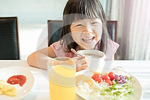 Cute girl eat breakfast