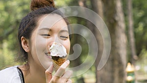Cute girl eat ice cream in close up face feeling delicious