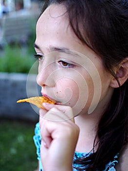 A Cute Girl Eating Chips