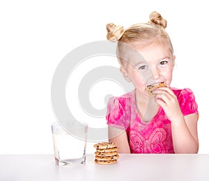 Cute girl eating a chocolate chip cookie