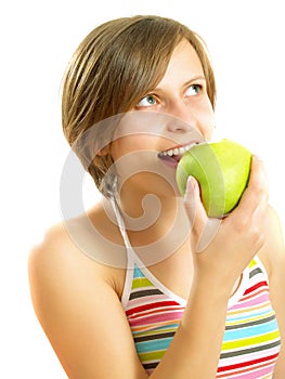 Cute girl eating a fresh green apple