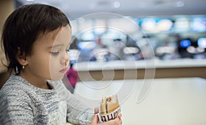 Cute girl eating a hamburger in the Fast food