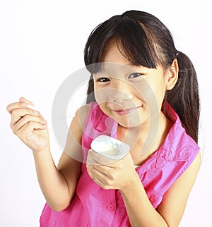 Cute girl eating yogurt