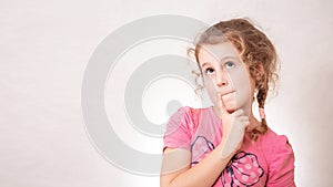 Cute girl eight years old with Curly hair on gray background