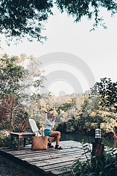 girl enjoy with the nature resting and looking on the river
