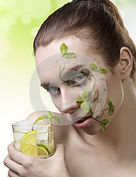 Cute girl with fresh make-up drinking cocktail