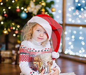 Cute girl with gift box looking at camera