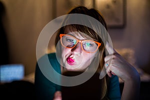 Cute girl with glasses looking at her phone