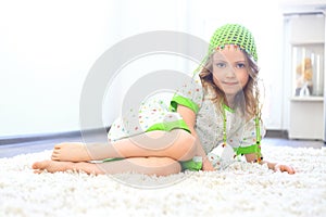 Cute girl green hat white carpet