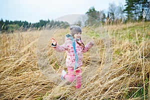 Cute girl having fun on beautiful spring day. Active family leisure with kids. Family fun outdoors