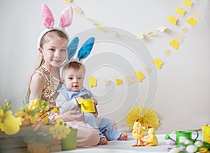 Cute girl and her little brother wearing bunny ears