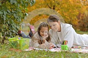 Cute girl with her mother doing homework