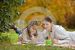 Cute girl with her mother doing homework