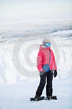 Cute girl hiking in snowshoes