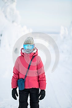 Cute girl hiking in snowshoes