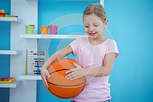 Cute girl holding basket ball