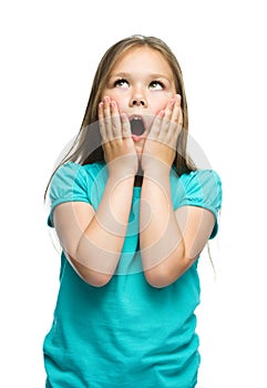 Cute girl is holding her face in astonishment