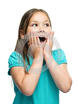 Cute girl is holding her face in astonishment photo