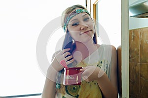 Cute girl holding a pot of freshly made coffee