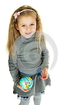 Cute girl holding small globe in her hands