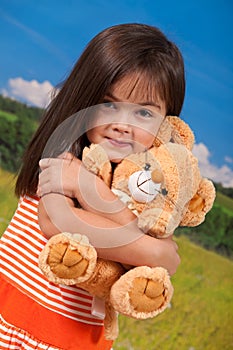 Cute girl holding soft toy