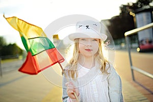 Cute girl holding tricolor Lithuanian flag on Lithuanian Statehood Day