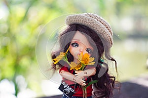 A cute girl holding a yellow flower in the morning blur background