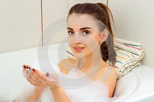 Cute girl in the hot tub with foam
