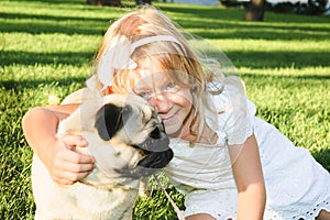 Cute girl hugging with lovely dog at the park