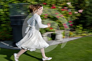 Cute girl joyous affirmation running in festive clothes for new appointed day for First Communion in autumn 2020, 6 months to late