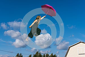 Cute girl jumping funny in clouds