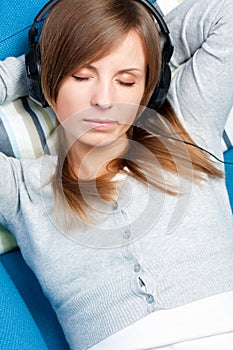 Cute girl listening to music. Eyes closed