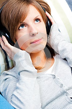 Cute girl listening to music. Eyes open