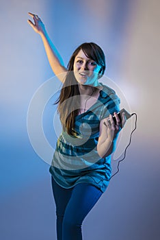 Cute girl listening to music on ipod or mp3 player